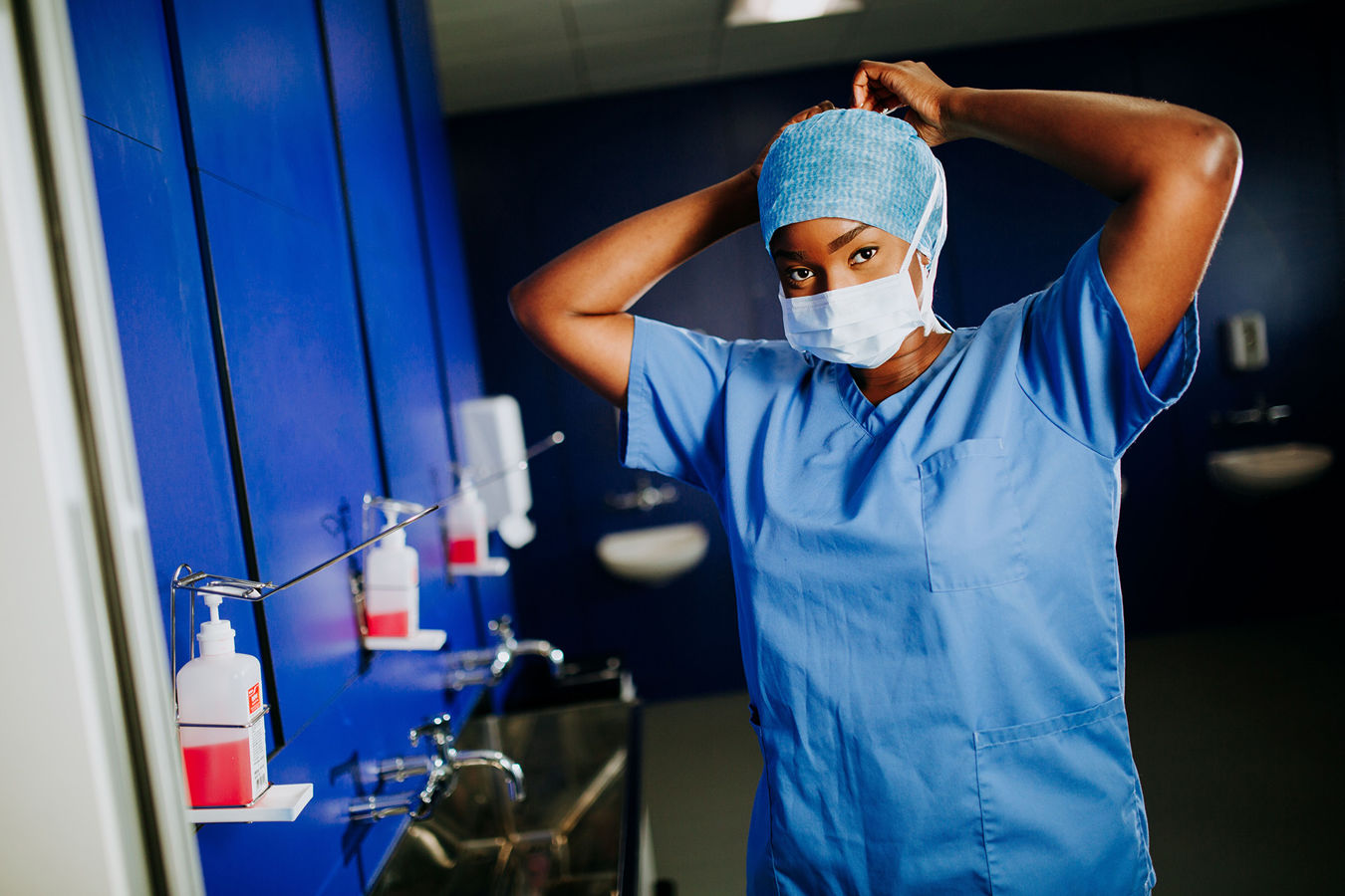 A nursing student wearing a protective gown and mask