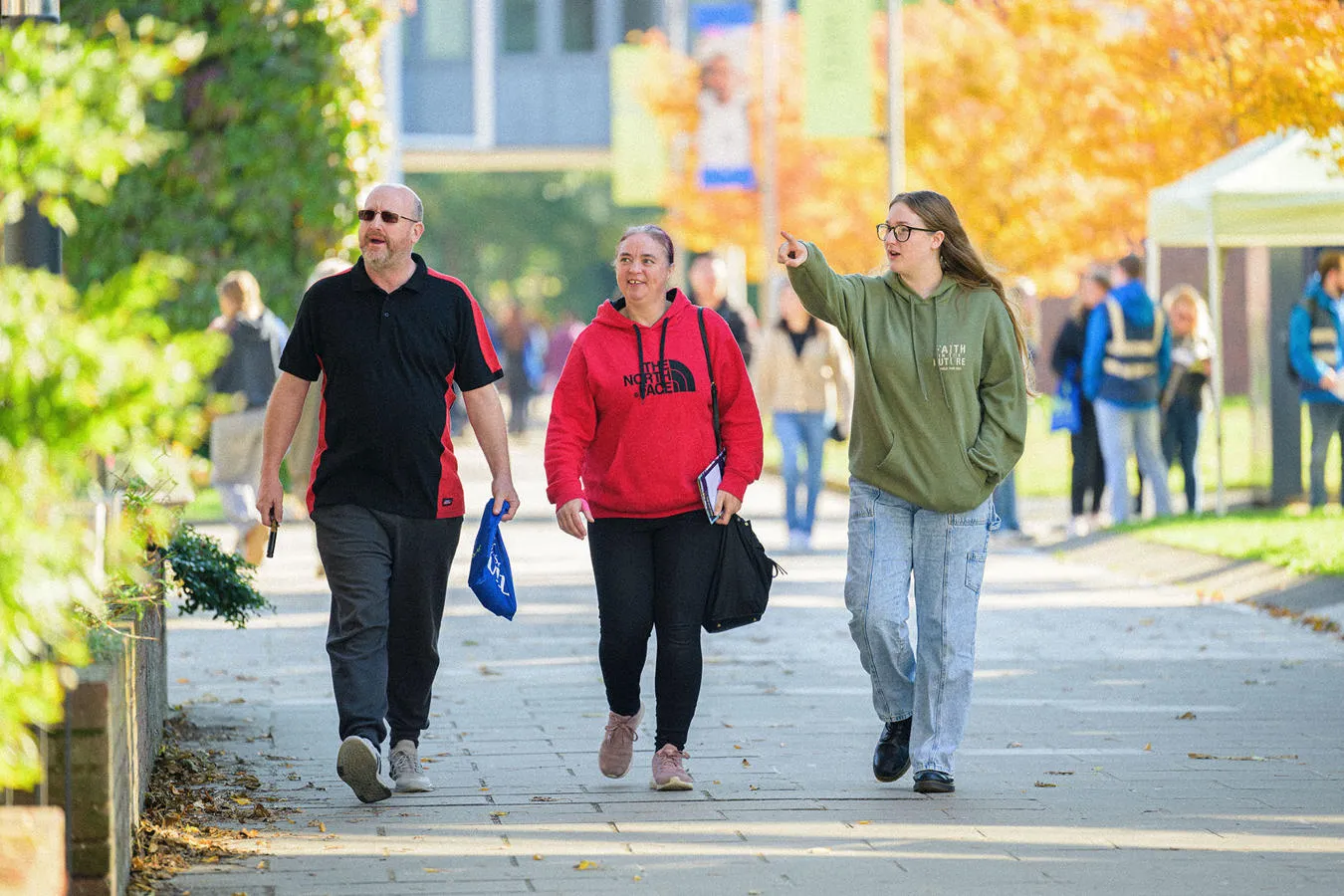 A prospective student at an open day with her parents
