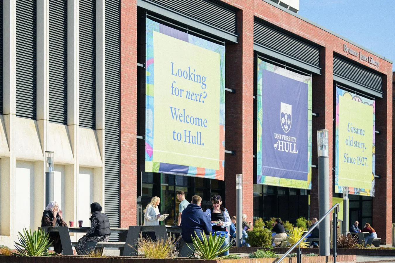 Students enjoying an open day with the library building in the background
