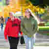 Two students walking across the University of Hull campus at an autumn open day