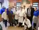 A group pf young people in chef uniforms with the Humberside Police and Crime Commissioner Jonathan Evison