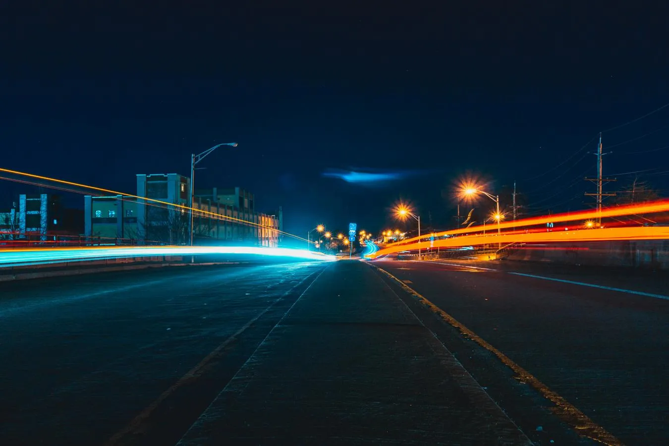 Long exposure photography showning streaks of light on a dark street