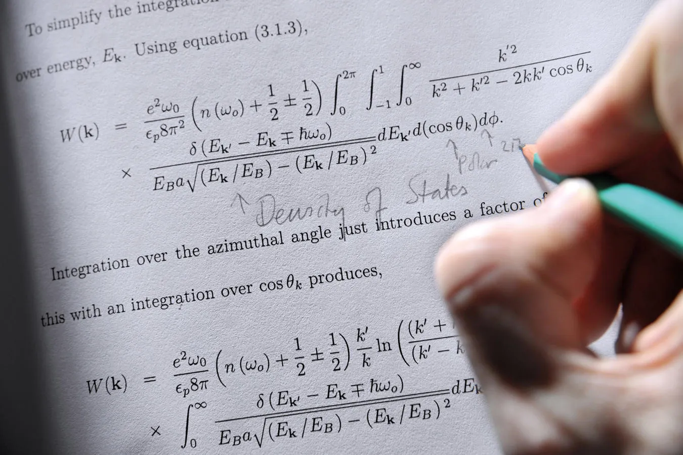 Student writing notes next to an equation