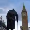 The statue of Winston Churchill in Parliament Square, London, with Big Ben nearby.