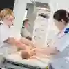 Midwifery students practice on a dummy