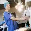 Anna Williams An ODP student in surgical scrubs standing in front of medical equipment