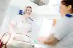 Two student midwives in white uniforms
