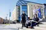 Students standing outside the Allam Medical Building on campus