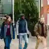 Three Business students walking out of the University's Nidd building