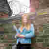 A Criminology student leaning against a wall outside Hull Prison
