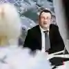Man sits at a desk with an open laptop