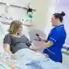 A midwifery student in a ward performing a blood pressure check