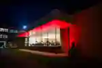 External shot of Mididleton hall at night with red lights