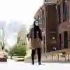A student wearing a headscarf walks through the university campus
