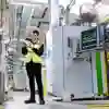A mechanical engineering student intern in hi-vis is pictured at Howden's Joinery