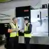 Two workers in hi-vis pictured at at Howdens Joinery