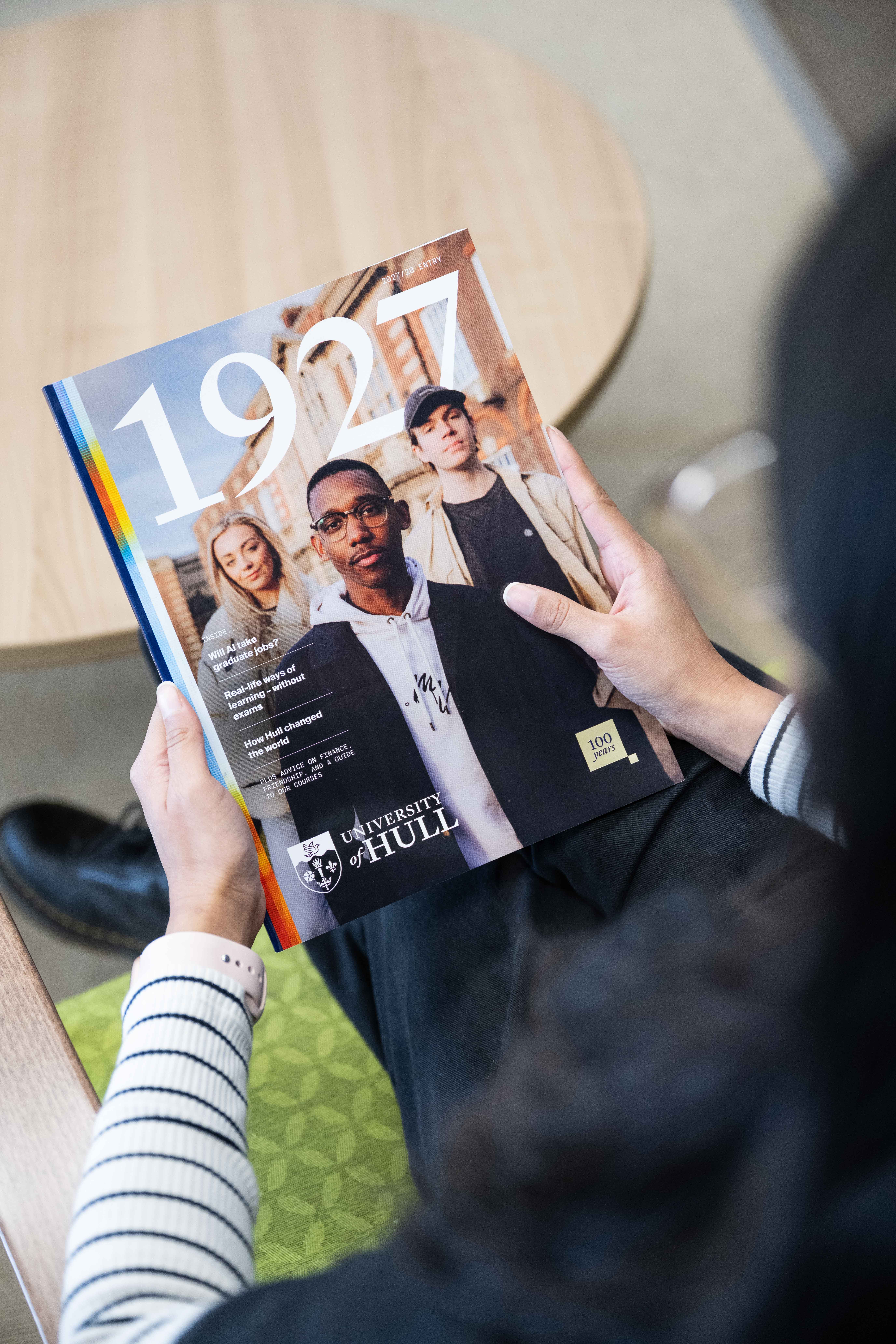 Person holding a copy of the University of Hull prospectus 