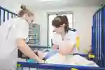 Two medical students assessing a young patient