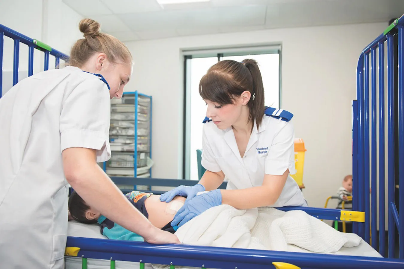 Two medical students assessing a young patient