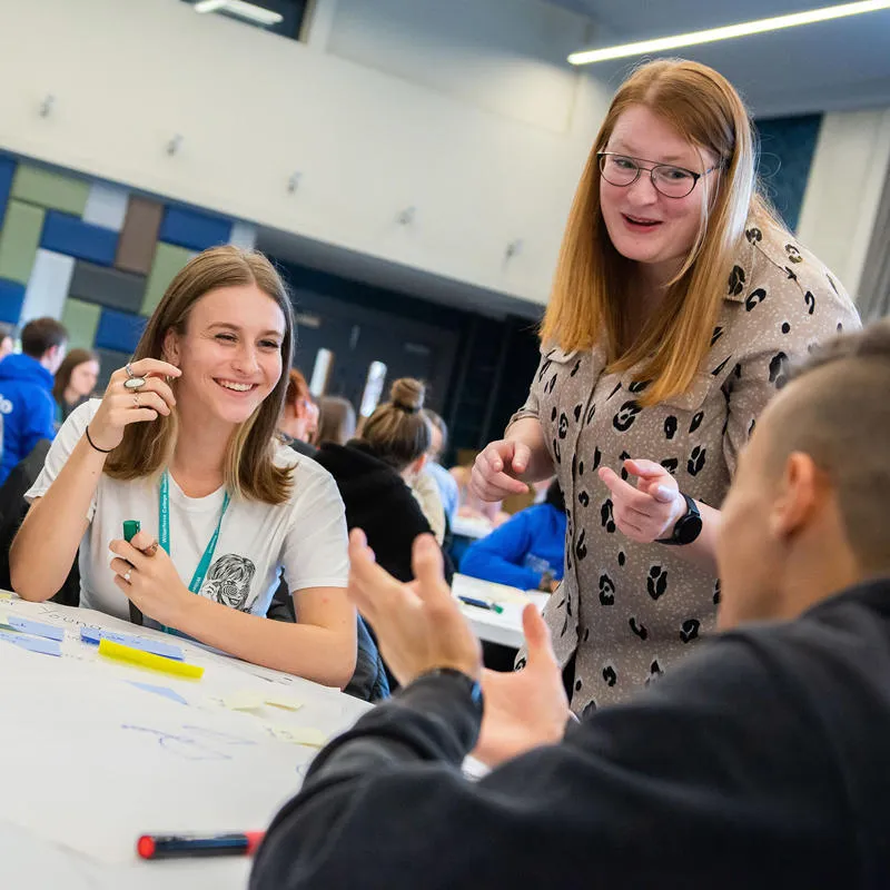 secondary students sat around a table in a marketing workshop