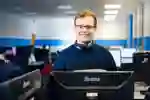 Computer Science student standing in a computer suite at the University of Hull