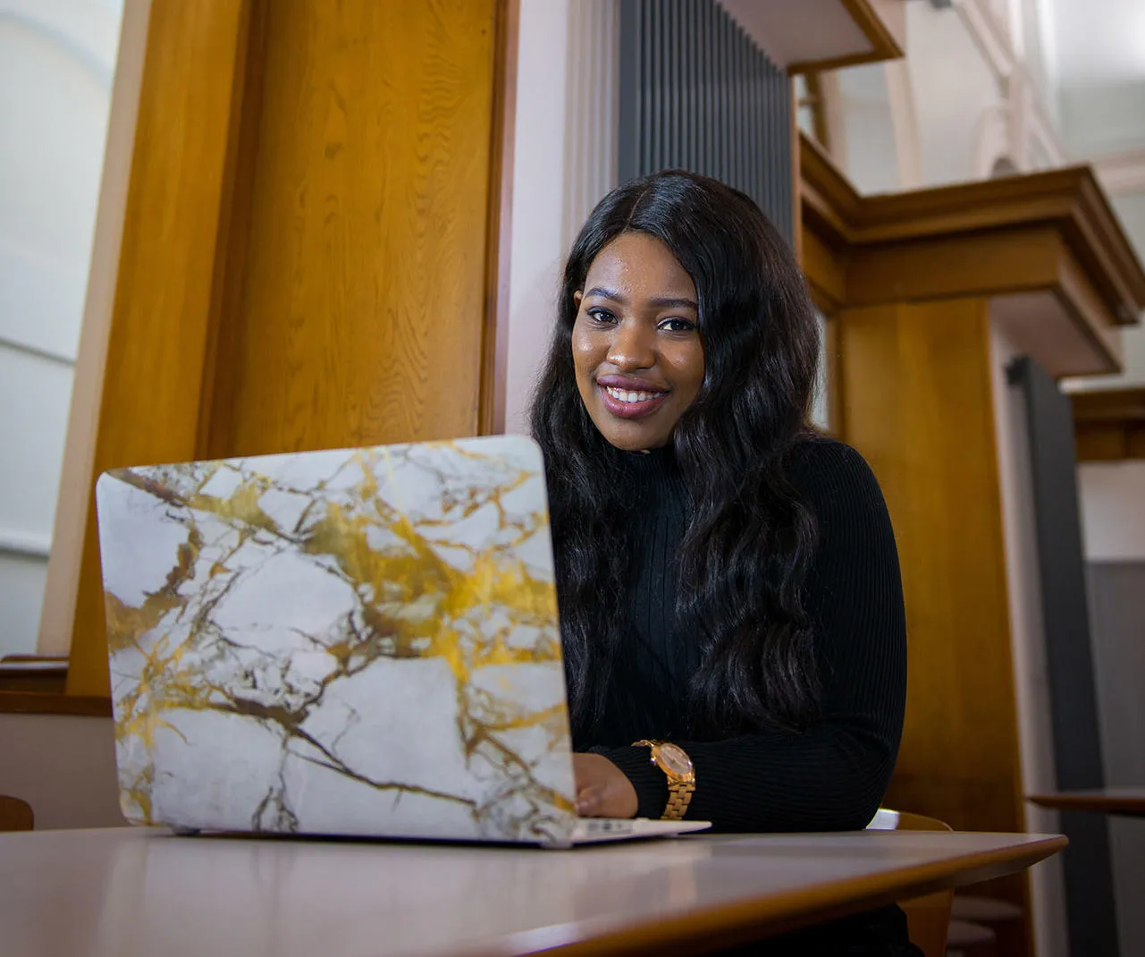 Student sitting at a desk with an open laptop
