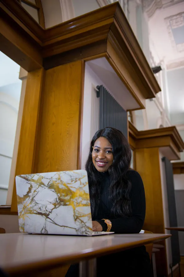 Student sitting at a desk with an open laptop