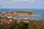 An aerial view of the seaside town of Scarborough showing the seafront surrounding a large bay