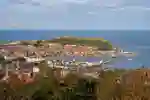 An aerial view of the seaside town of Scarborough showing the seafront surrounding a large bay