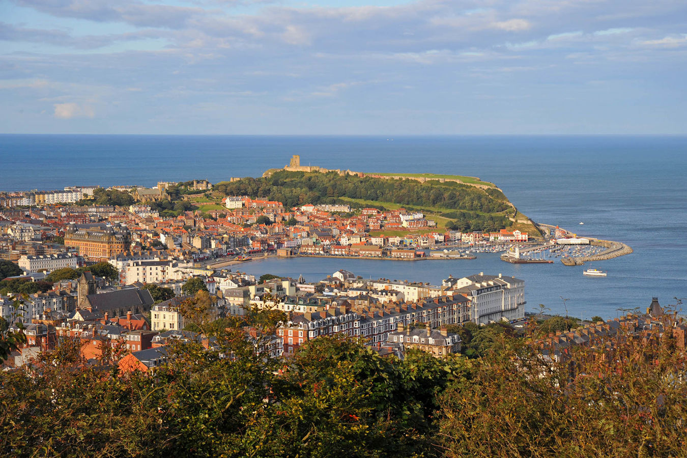 An aerial view of the seaside town of Scarborough showing the seafront surrounding a large bay