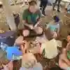 A group of children sat on the ground