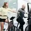 Two people exercising on stationary bikes in the Strength and Conditioning Suite on campus.
