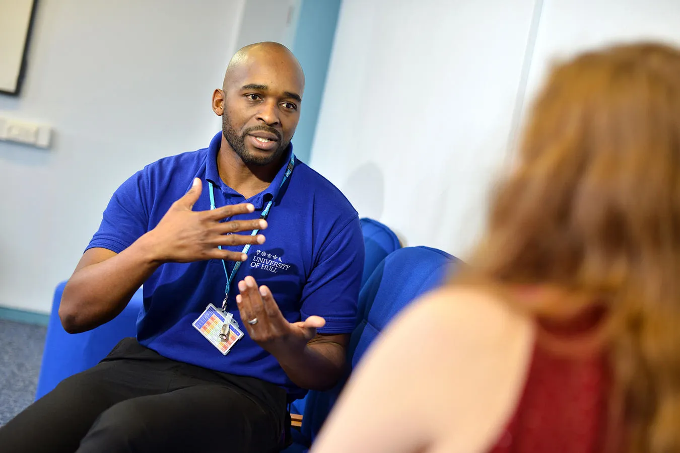 A mental health nurse speaking with another person