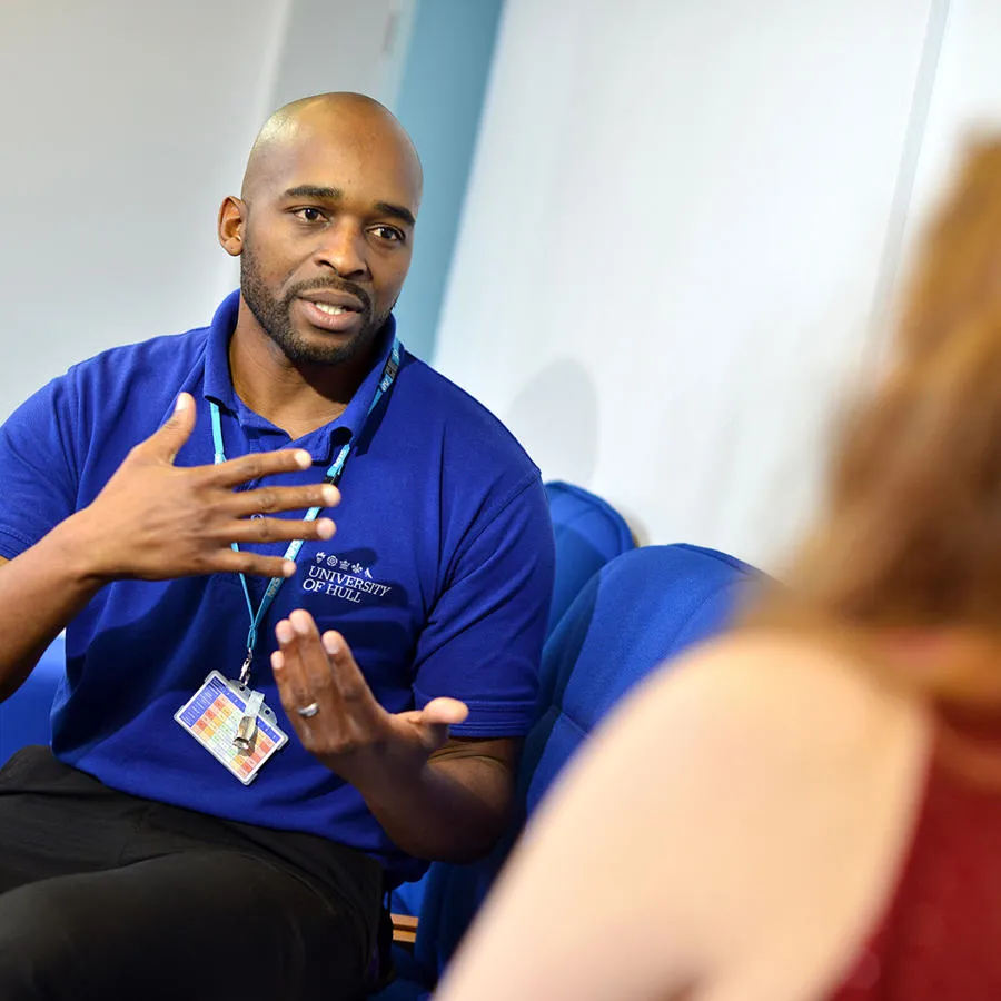 A mental health nurse speaking with another person