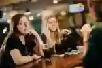 Students chatting over drinks in the bar