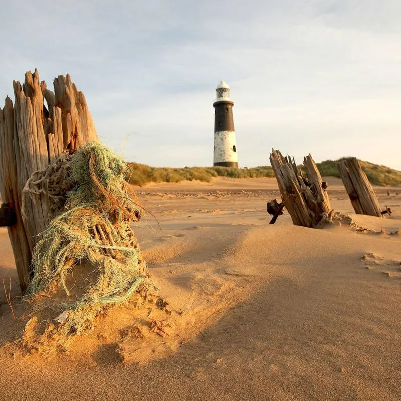 spurn point lighthouse from a distance showing the sandy beach around