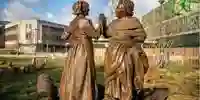 A bronze sculpture of two factory workers by Rachel Carter in the new Broadmarsh gardens in Nottingham
