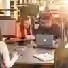 a group of students studying at a bank of computers