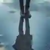 Reflection of a figure in a puddle