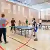 students playing table tennis inside sports hall