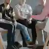 Four teenagers sat in a group discussion with an adult.