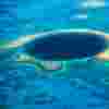 A large blue hole within a reef in the ocean