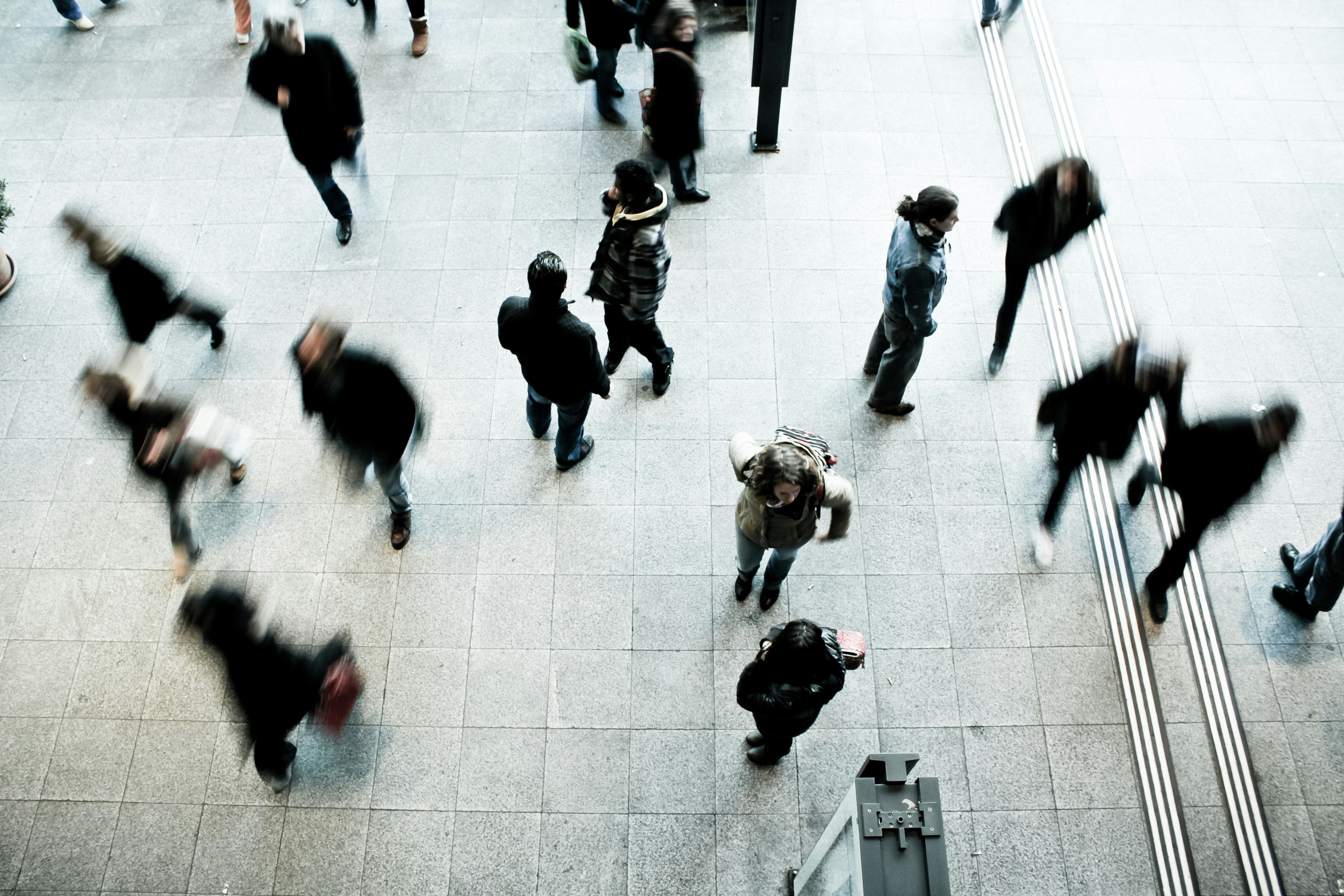 People in a train station seen from above