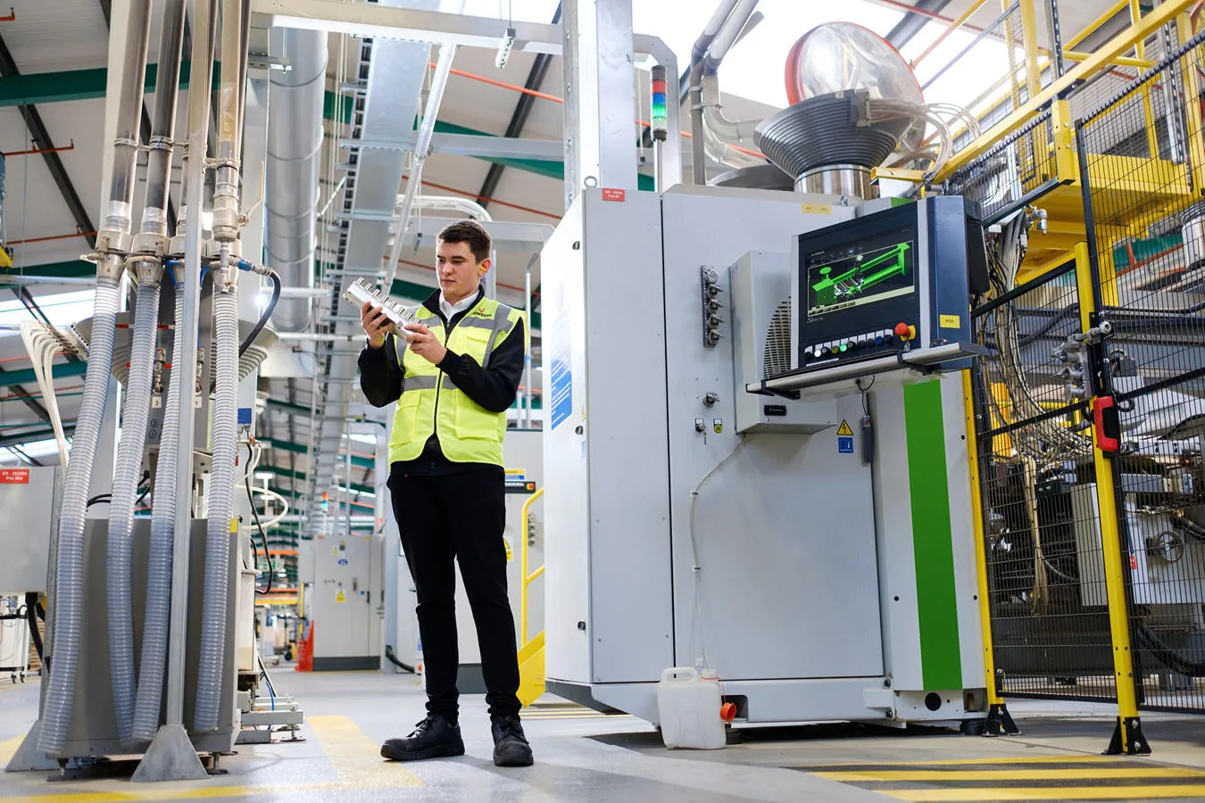 A mechanical engineering student intern in hi-vis is pictured at Howdens Joinery