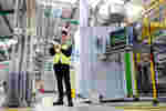A mechanical engineering student intern in hi-vis is pictured at Howdens Joinery