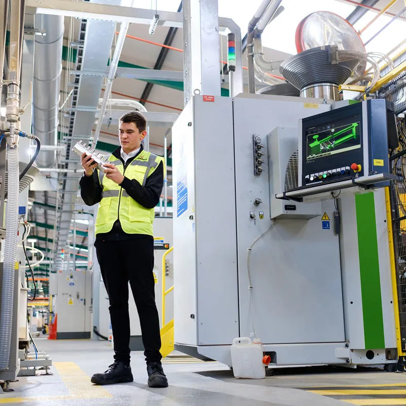 A mechanical engineering student intern in hi-vis is pictured at Howden's Joinery