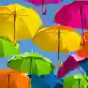 Colourful umbrellas against a blue sky