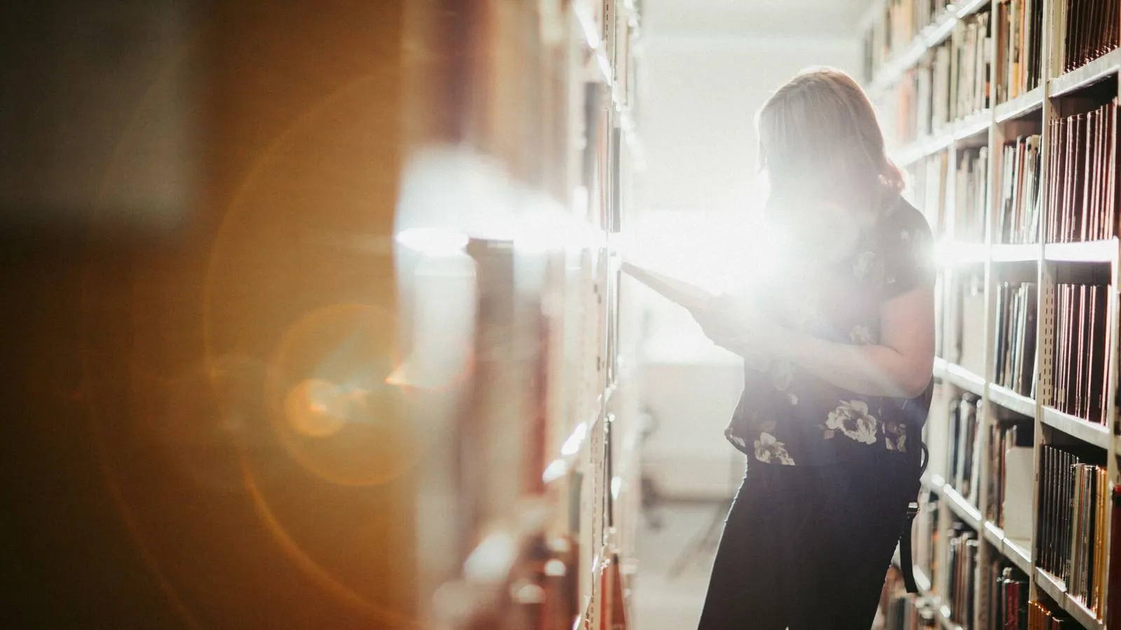 A student reading a book in the library