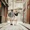 two students walking down a historic cobbled street