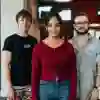 3 students standing confidently in the allam medical building